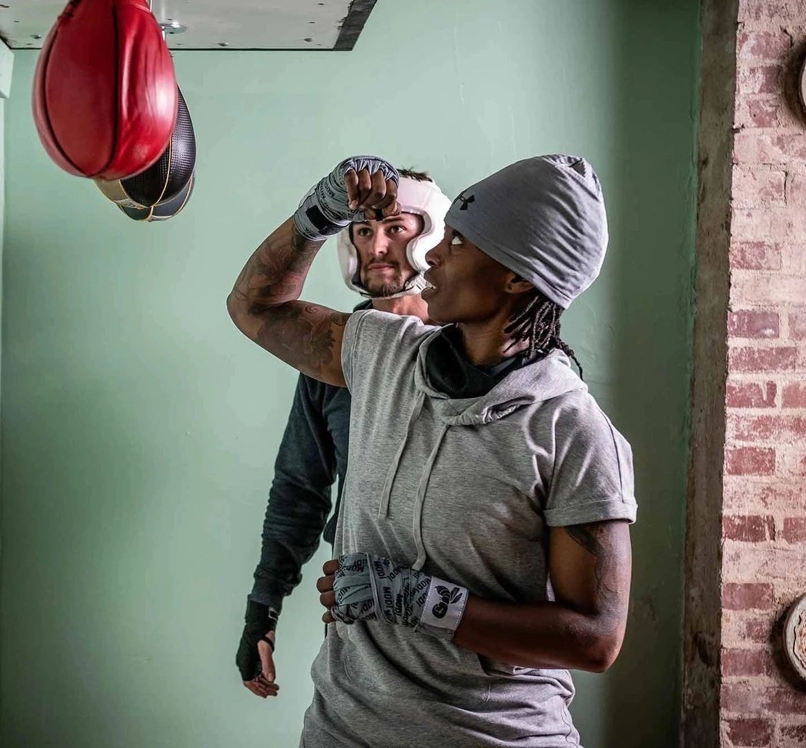 Boxer punching heavy bag at Muletown Boxing Club